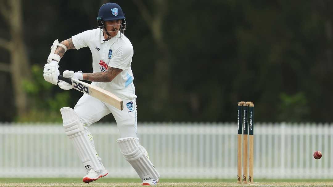 Australian cricketer raises bat during domestic innings
