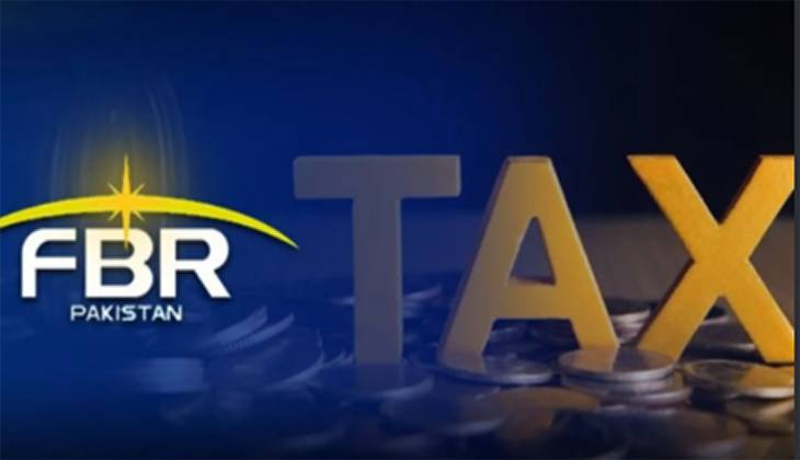 Government officials and tax administrators at a desk with digital screens representing tax modernization in Pakistan