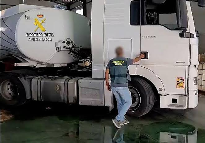 Sealed fuel depot with Guardia Civil tape and officers at the scene