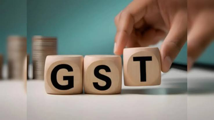 Stack of Indian currency notes and tax documents representing GST revenue