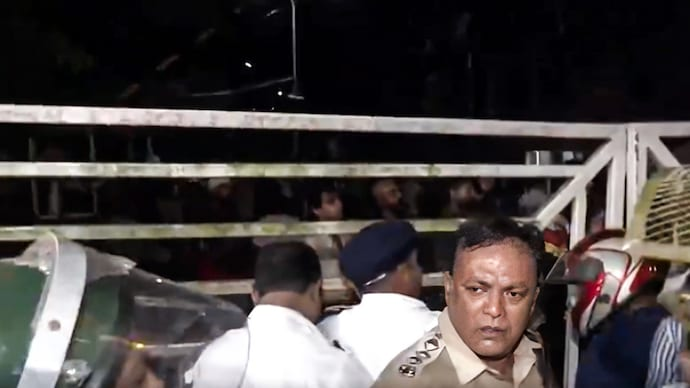 Students and police outside a film institute gate after a protest