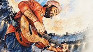 Arijit Singh performing on stage in front of large crowd
