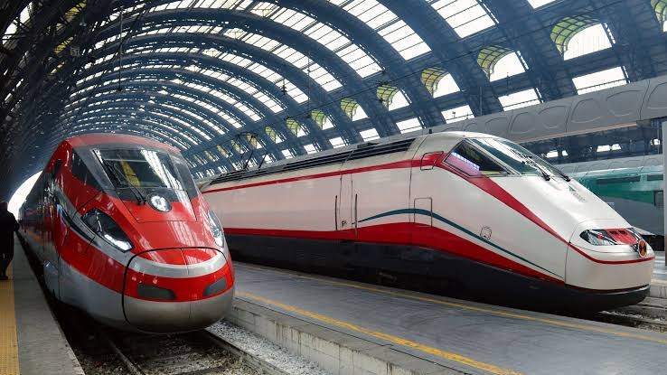 Passengers at an Italian train station looking at timetables during a strike