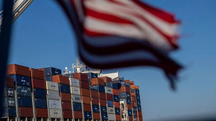 Container ship at port with cranes, representing U.S. trade