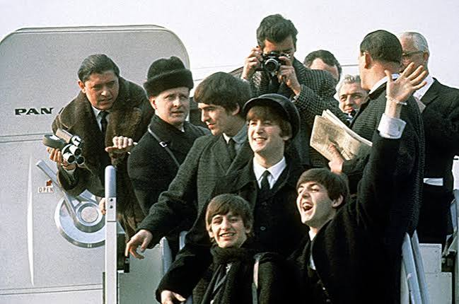 Film crew and cast recreating a Beatles era street scene in Liverpool
