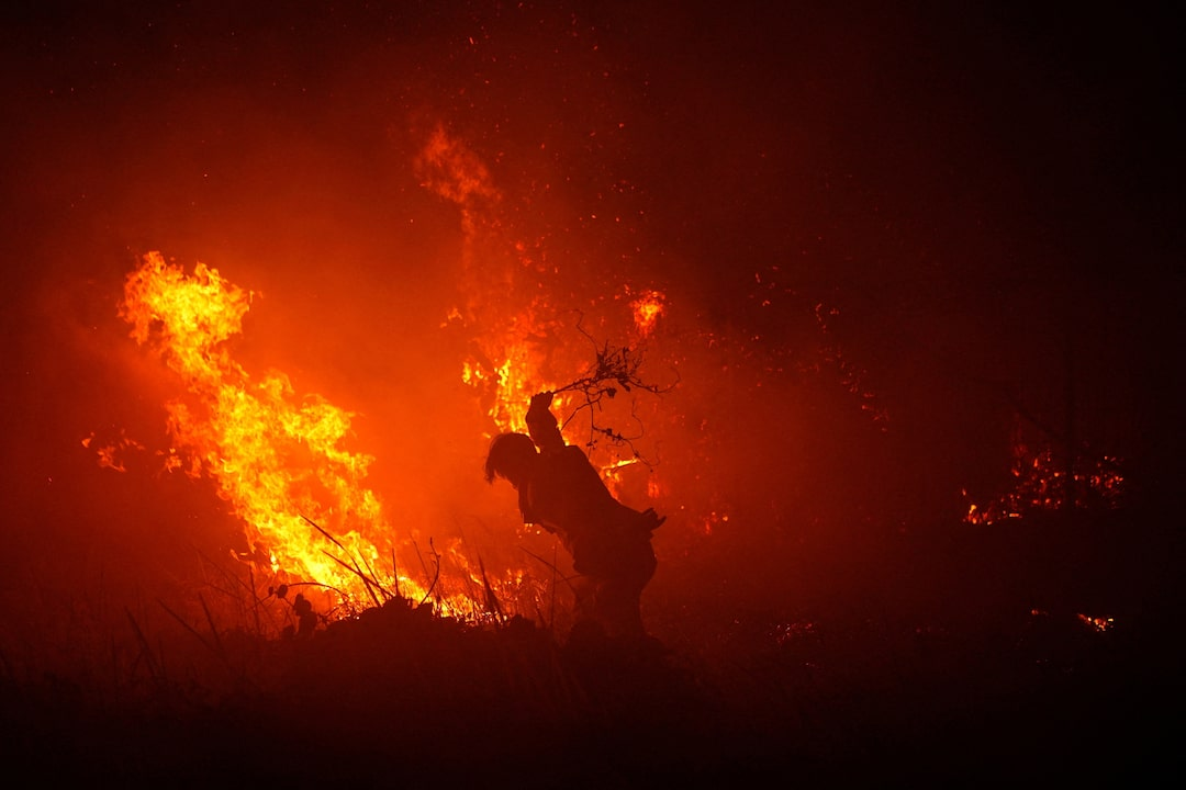 Smoke rising from peatland and forest fires in Kalimantan, Indonesia, with an orange sky