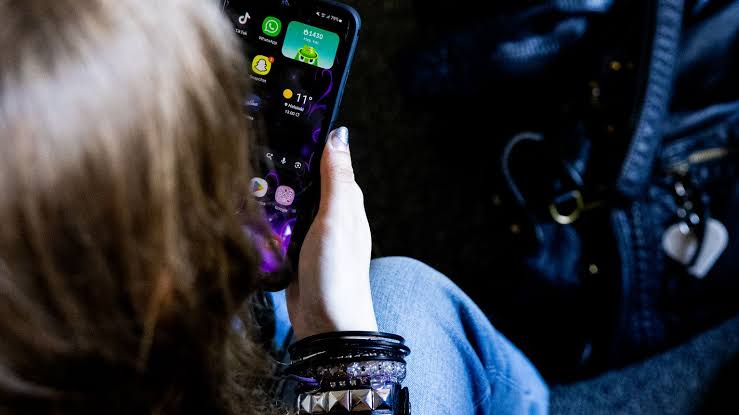 Finland flag and a smartphone showing social media icons